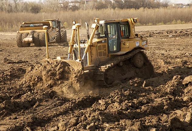 A bulldozer performs dirtwork.