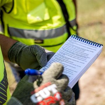 person writing on notepad