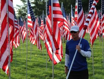 A person carrying a U.S. flag.