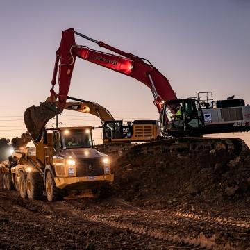 Construction workers on a jobsite operating heavy machinery