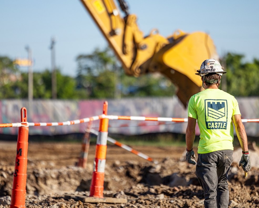 person standing in front of dig site