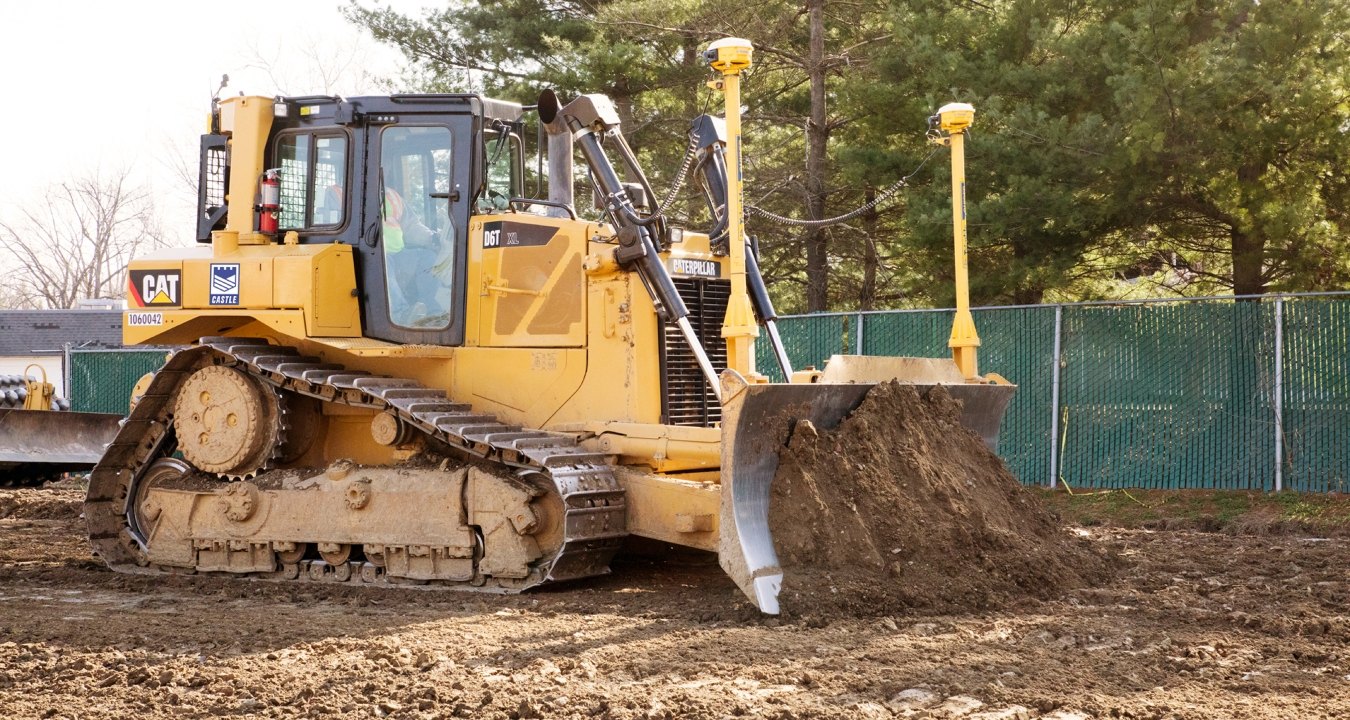 Yellow bulldozer pushing earth