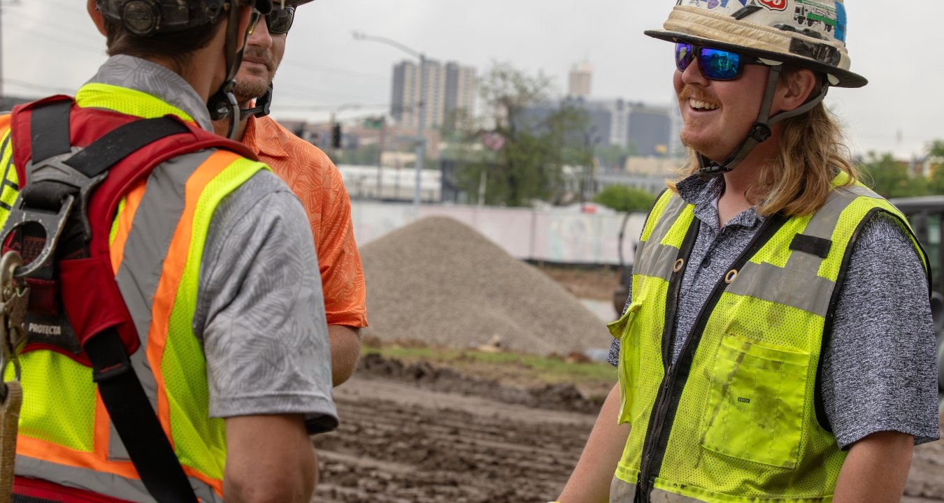 Three people talking while on a jobsite