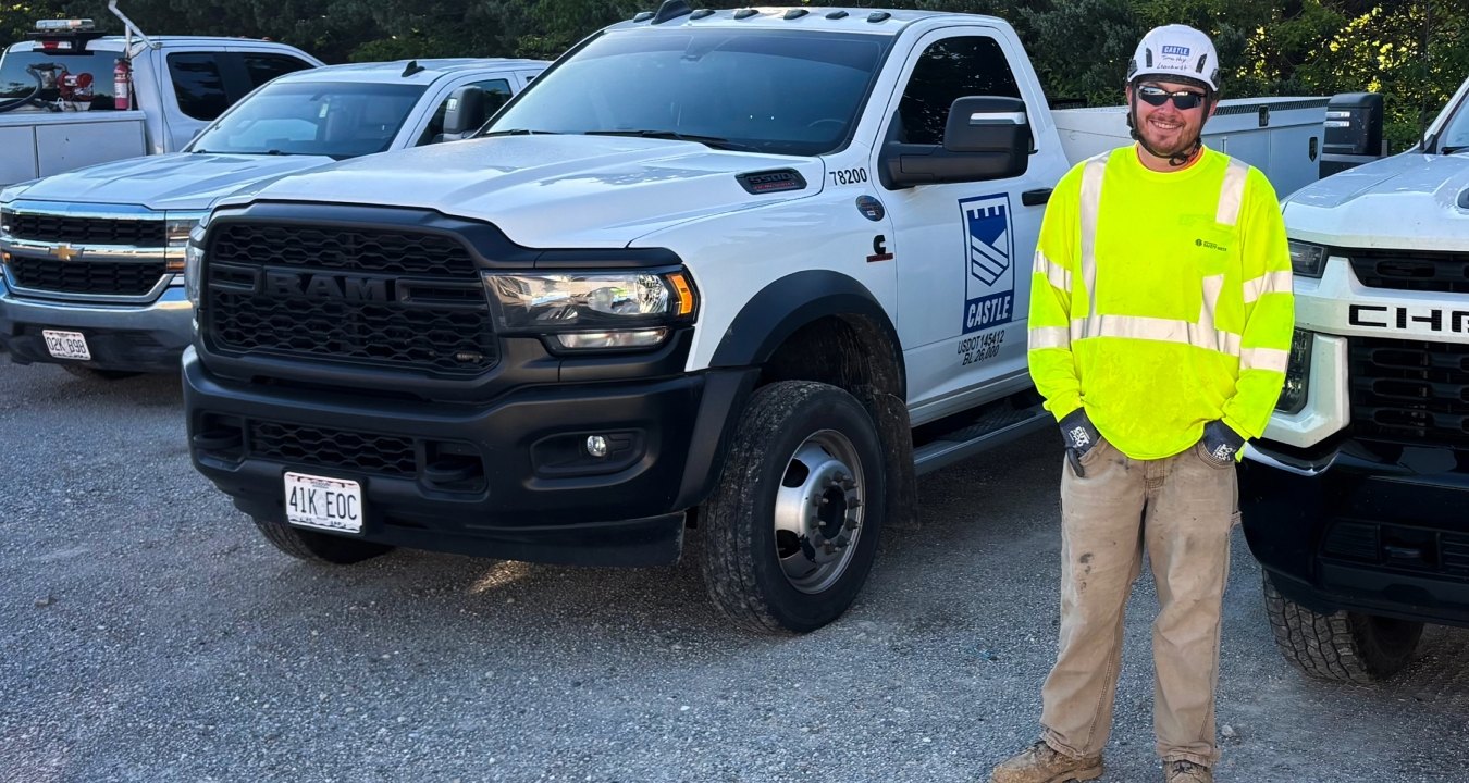Tim Leonhardt in full PPE standing next to Castle Contracting truck