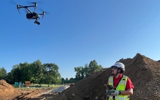 Person a jobsite flying a drone