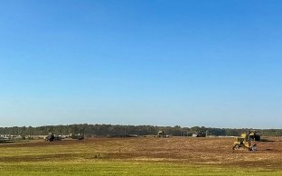 Open green field and blue sky rural landscape