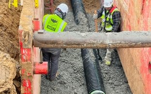 Two construction workers in boring pit