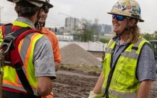 Three people talking while on a jobsite