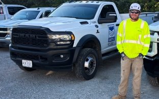 Tim Leonhardt in full PPE standing next to Castle Contracting truck