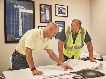 people looking over project plans