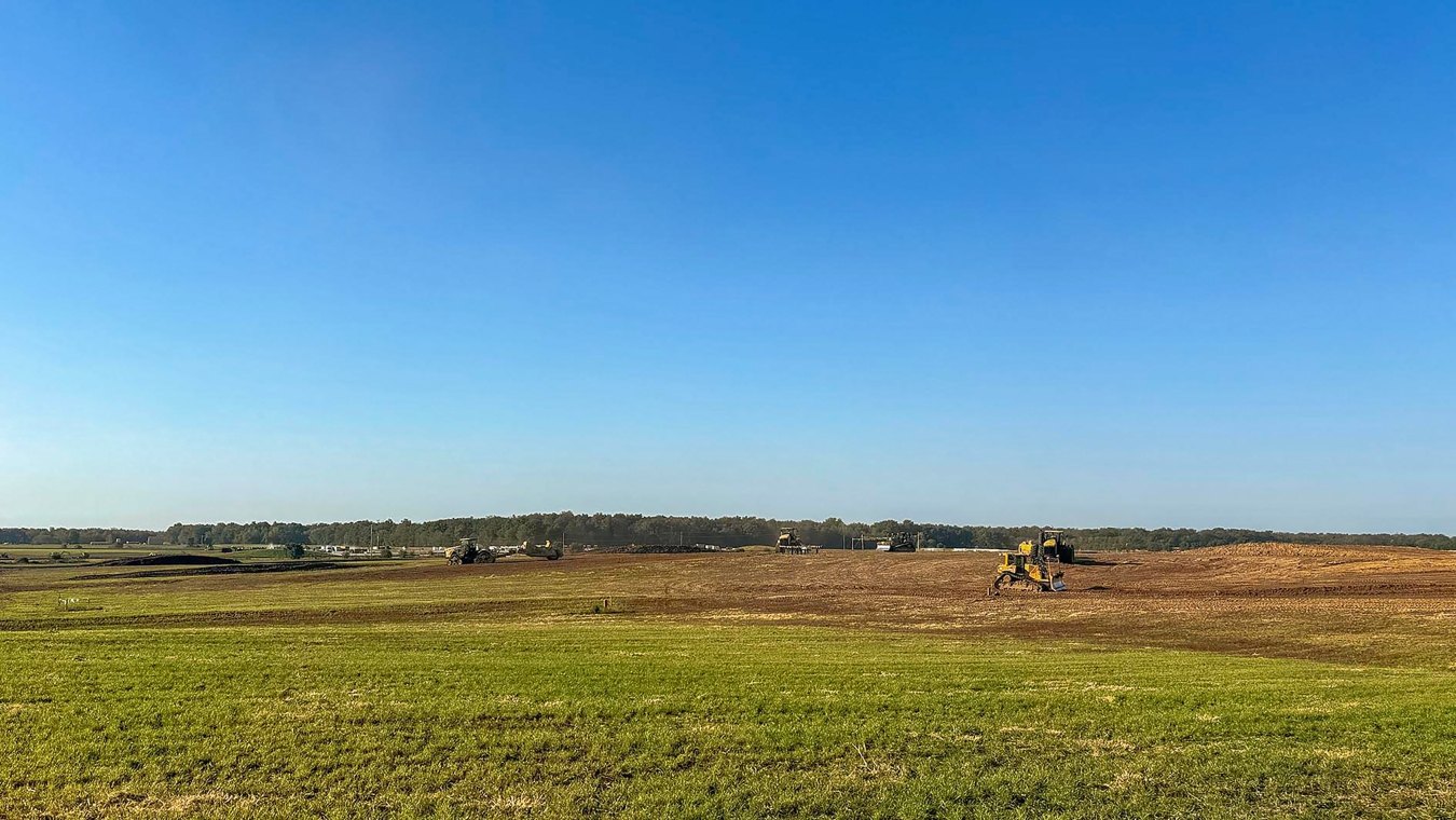 Open green field and blue sky rural landscape