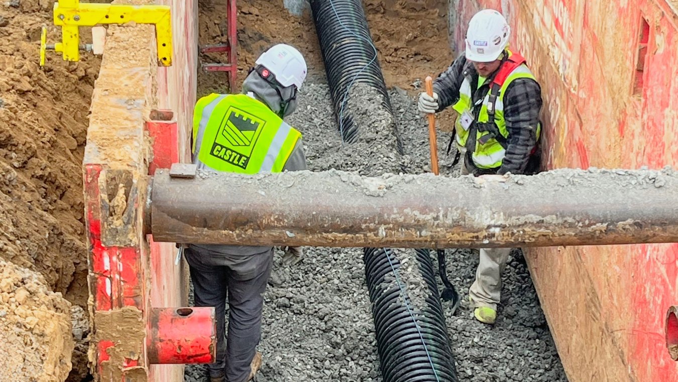 Two construction workers in boring pit