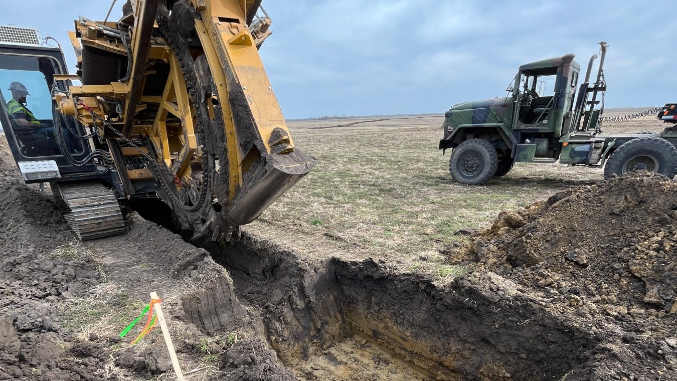 Castle Contracting construction worker operating paddle trencher