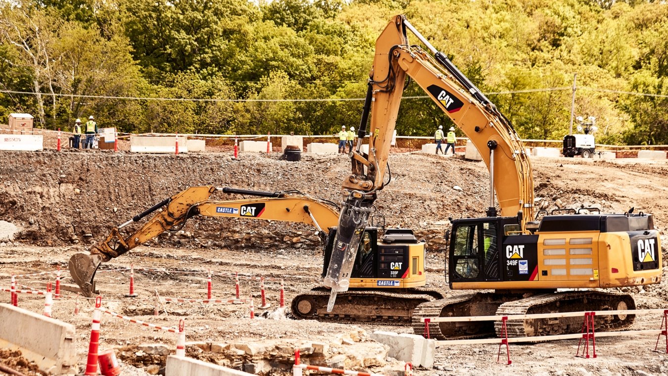 Yellow CAT excavator and GC Hammer operating on jobsite