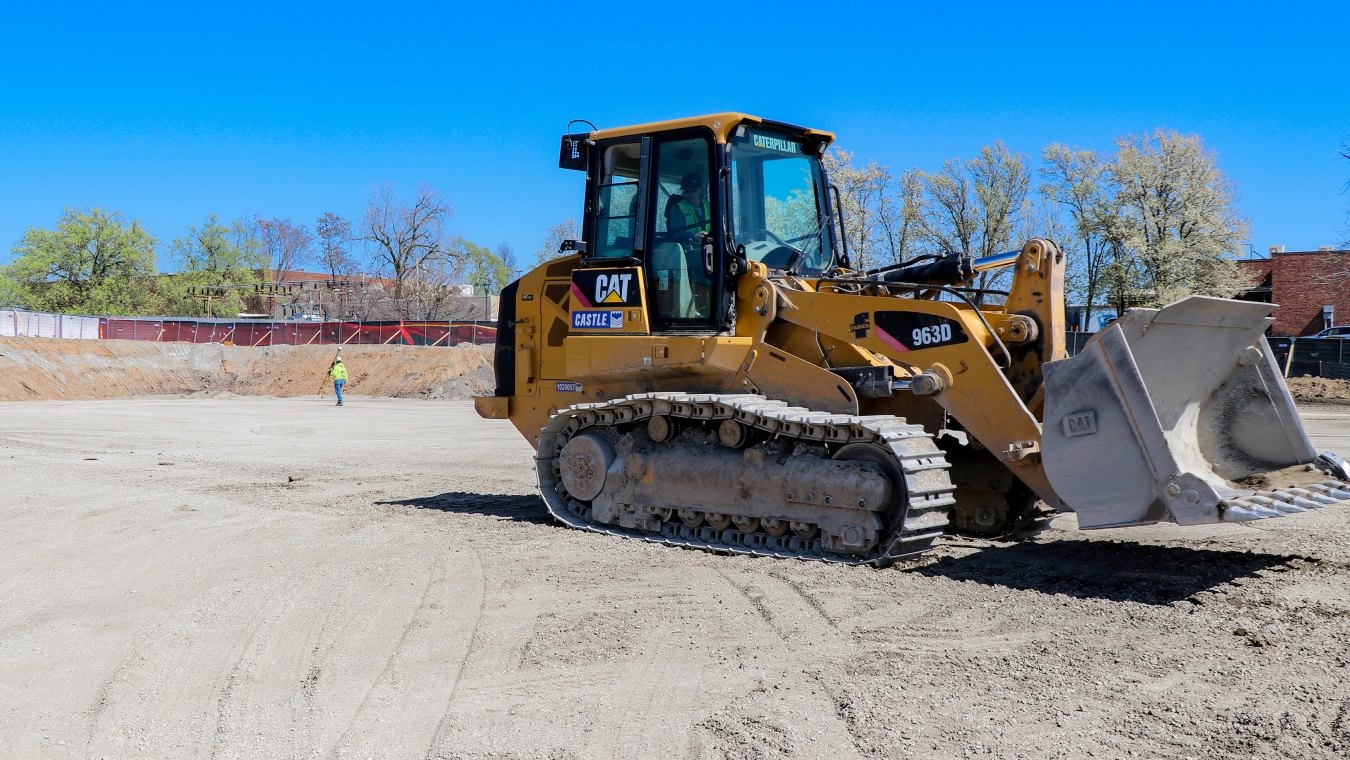 Operator in dozer and laborer in background STLCC project site