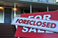 foreclosure sign in front of a house
