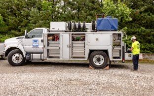person next to castle work truck