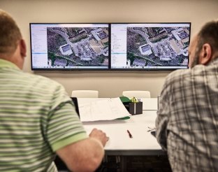 people working discussing map together