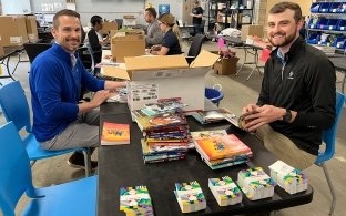 Two people sorting through donations