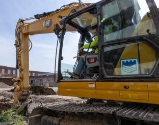 Yellow Caterpillar excavator operating