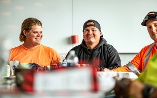 Two people smiling while sitting at a table