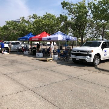 Parking lot with tents and a castle truck