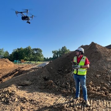 Person a jobsite flying a drone