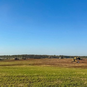 Open green field and blue sky rural landscape