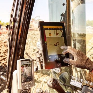 person using technology in excavator
