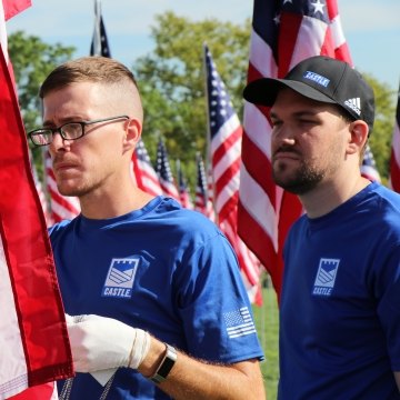 two people holding American flags