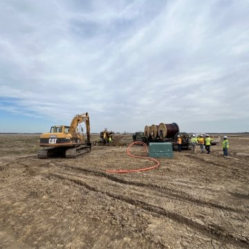 Excavator operating on solar jobsite