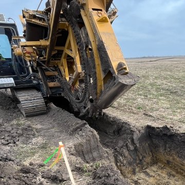 Castle Contracting construction worker operating paddle trencher