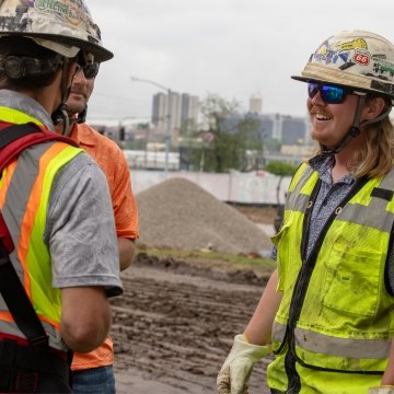 Three people talking while on a jobsite