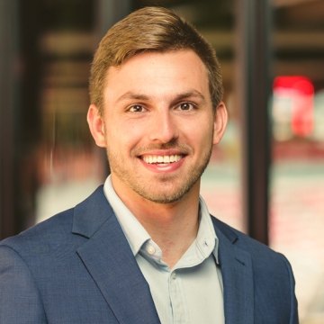 Portrait image of smiling Alex Fesi in office