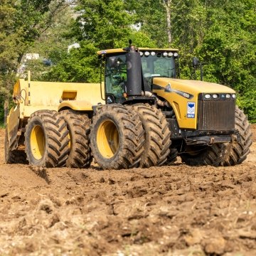 Yellow heavy construction equipment tractor and scraper