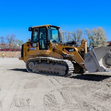 Operator in dozer and laborer in background STLCC project site